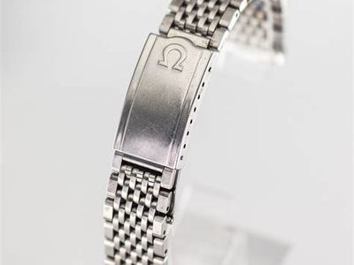 Omega fold-over clasp with raised logo (search photo)